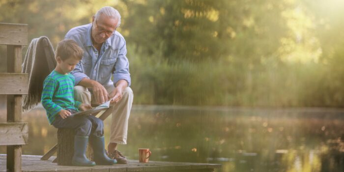 A Grandfather and Grandson sitting on a bench together