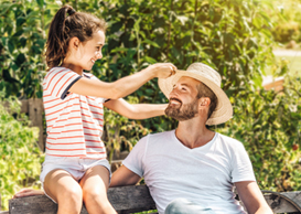 A father, smiling while looking at his daughter