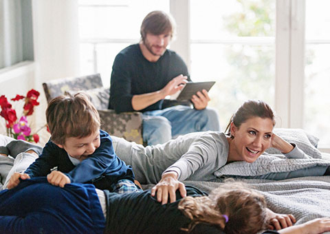 A family of four, relaxing together and having fun