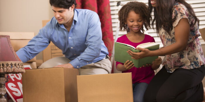 A family unpacking boxes in their new home